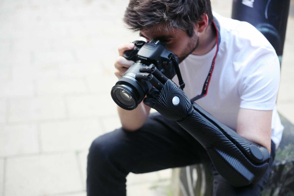 Person using a DLSR camera with the Hero Arm