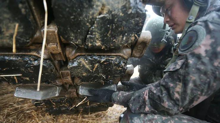 Korean soldier installing the ice cleat