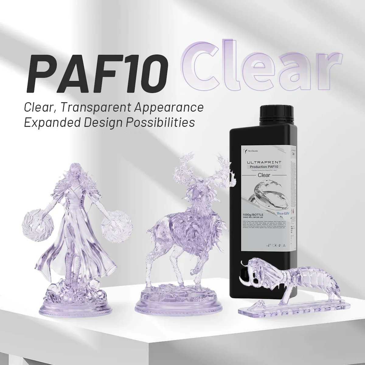 HeyGears' new UltraPrint Production PAF10 clear 3D printing resin shown alongside transparent miniatures demonstrating crystal-like clarity, including (from left to right) a fantasy character figurine, a unicorn, and a scorpion