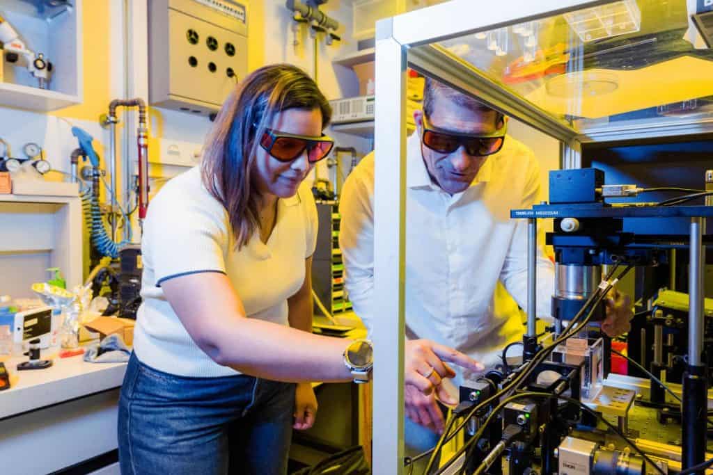 PhD student Maria Alvarez-Castaño and Professor Christophe Moser examining the holographic volumetric 3D printing platform in the EPFL Laboratory of Applied Photonic Devices